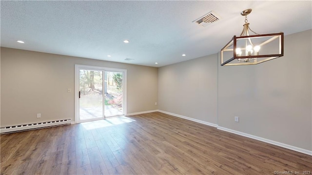 12 Cardinal Dr Unit 12, Farmington, CT 06032 - empty room featuring baseboard heating, wood finished floors, a chandelier, baseboards, and recessed lighting