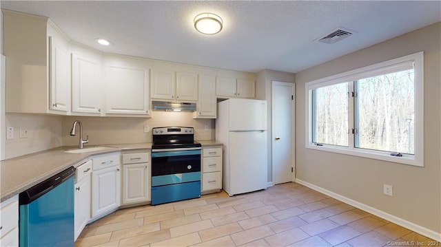 12 Cardinal Dr Unit 12, Farmington, CT 06032 - kitchen with freestanding refrigerator, stainless steel electric range oven, dishwashing machine, a sink, and under cabinet range hood