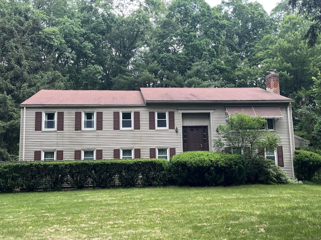 35 Chestnut Hill Rd, Simsbury, CT 06092 - split foyer home with a front yard and a chimney