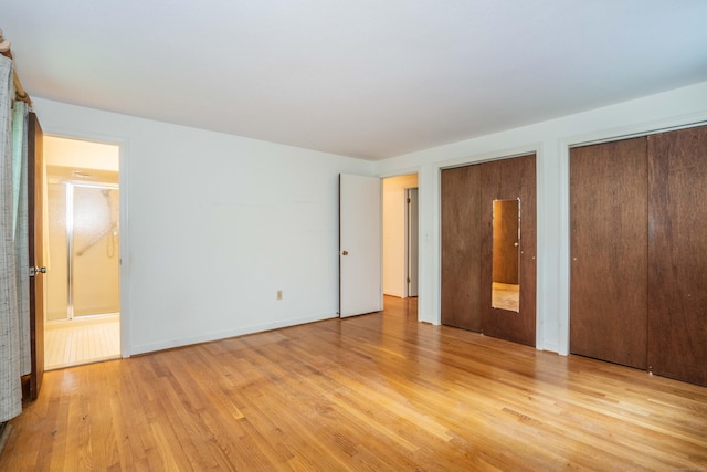 35 Chestnut Hill Rd, Simsbury, CT 06092 - unfurnished bedroom featuring two closets and light wood-style floors