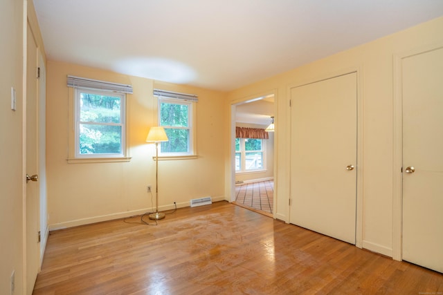 35 Chestnut Hill Rd, Simsbury, CT 06092 - unfurnished bedroom featuring multiple windows and light wood finished floors