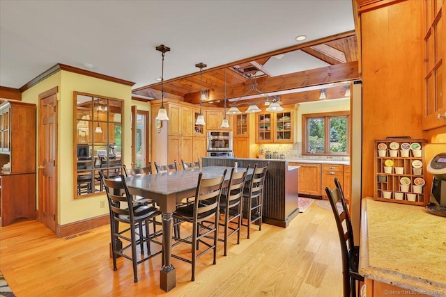 45 Snell Rd, Middlefield, CT 06422 - dining space featuring light wood-style floors, beam ceiling, crown molding, and recessed lighting