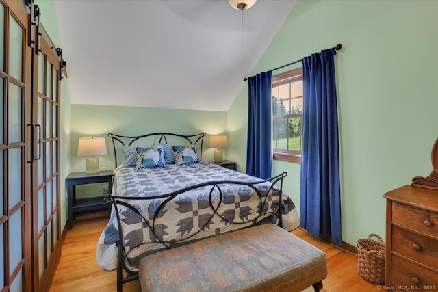 45 Snell Rd, Middlefield, CT 06422 - bedroom with lofted ceiling, a barn door, light wood finished floors, and ceiling fan