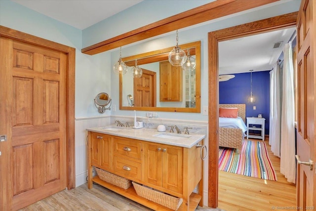 45 Snell Rd, Middlefield, CT 06422 - bathroom with wood finished floors, double vanity, wainscoting, and ensuite bathroom
