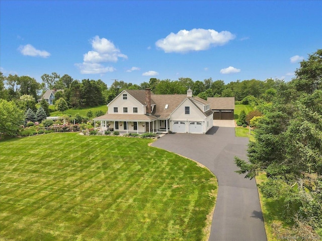 45 Snell Rd, Middlefield, CT 06422 - view of front of house featuring a porch, an attached garage, driveway, a front lawn, and a chimney