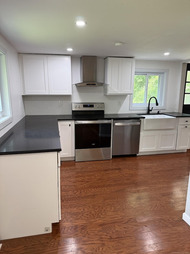 116 Howd Rd, Durham, CT 06422 - kitchen featuring appliances with stainless steel finishes, wall chimney range hood, recessed lighting, white cabinetry, and dark countertops