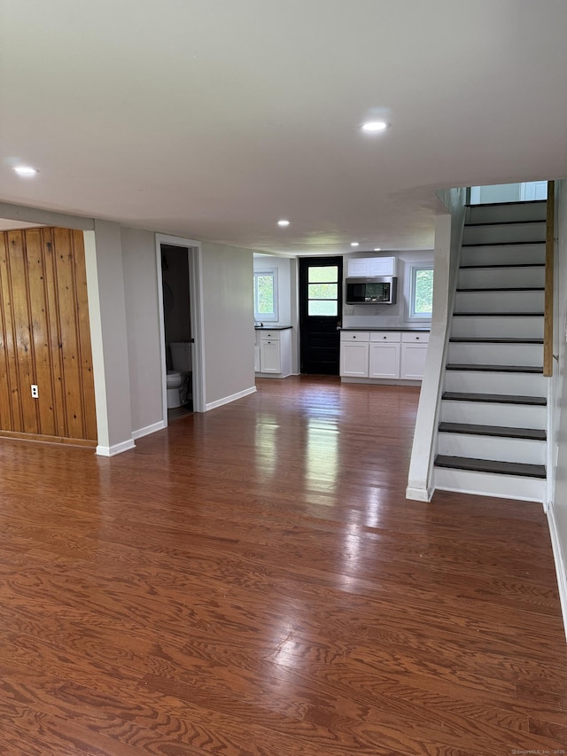 116 Howd Rd, Durham, CT 06422 - unfurnished living room with dark wood finished floors, stairs, recessed lighting, and wood walls