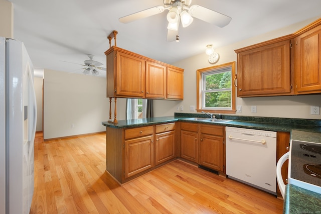 42 Cindy Ln, Groton, CT 06355 - kitchen with white appliances, ceiling fan, light wood finished floors, a peninsula, and brown cabinetry