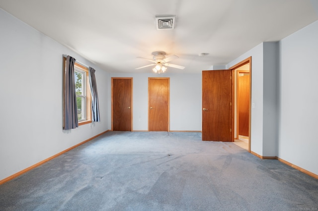 42 Cindy Ln, Groton, CT 06355 - unfurnished bedroom with two closets, carpet flooring, and a ceiling fan
