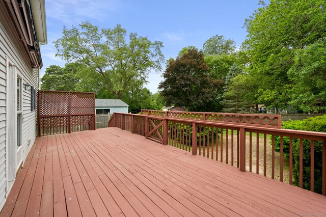 42 Cindy Ln, Groton, CT 06355 - wooden deck with a fenced backyard and view of scattered trees