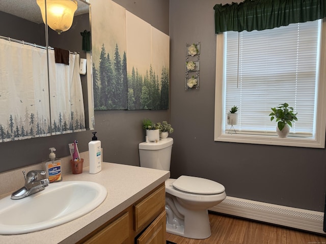 337 Zion St, Hartford, CT 06106 - bathroom with baseboard heating, vanity, wood finished floors, and curtained shower