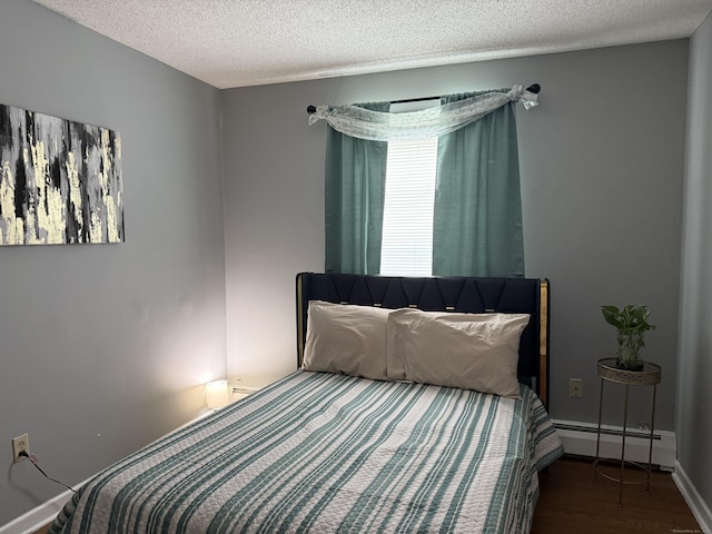 337 Zion St, Hartford, CT 06106 - bedroom featuring baseboard heating, a textured ceiling, and wood finished floors