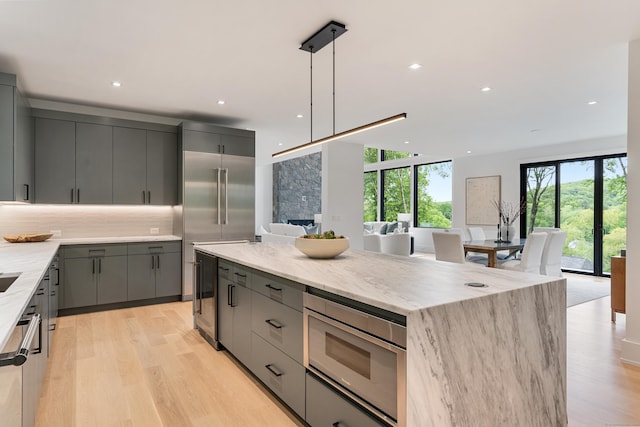 22 Limekiln Rd, Redding, CT 06896 - kitchen with gray cabinetry, beverage cooler, a center island, light wood finished floors, and recessed lighting