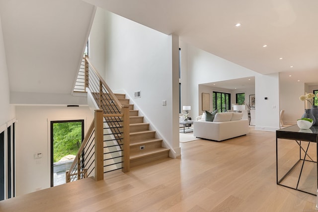 22 Limekiln Rd, Redding, CT 06896 - living area featuring recessed lighting, stairway, wood finished floors, a high ceiling, and baseboards