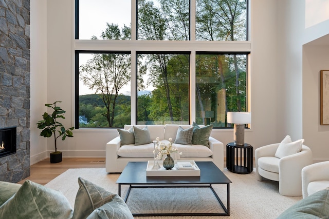22 Limekiln Rd, Redding, CT 06896 - living room featuring a high ceiling, wood finished floors, healthy amount of natural light, and a fireplace