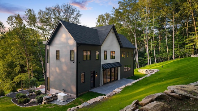 22 Limekiln Rd, Redding, CT 06896 - view of property exterior with a lawn, a patio area, and a shingled roof
