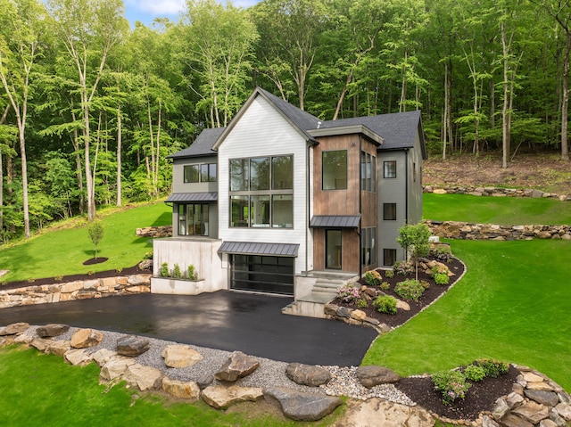 22 Limekiln Rd, Redding, CT 06896 - view of front of property featuring a standing seam roof, driveway, an attached garage, metal roof, and a front lawn