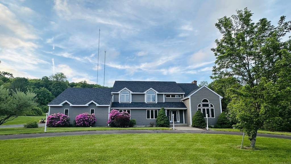 7 Trumbull Ln, Farmington, CT 06032 - view of front of house featuring a front lawn, a chimney, and roof with shingles