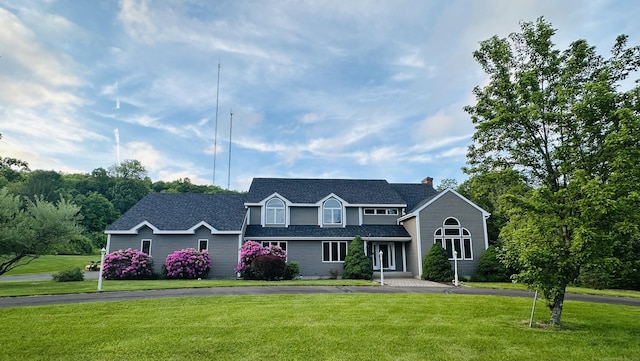 7 Trumbull Ln, Farmington, CT 06032 - view of front of house featuring a front lawn, a chimney, and roof with shingles