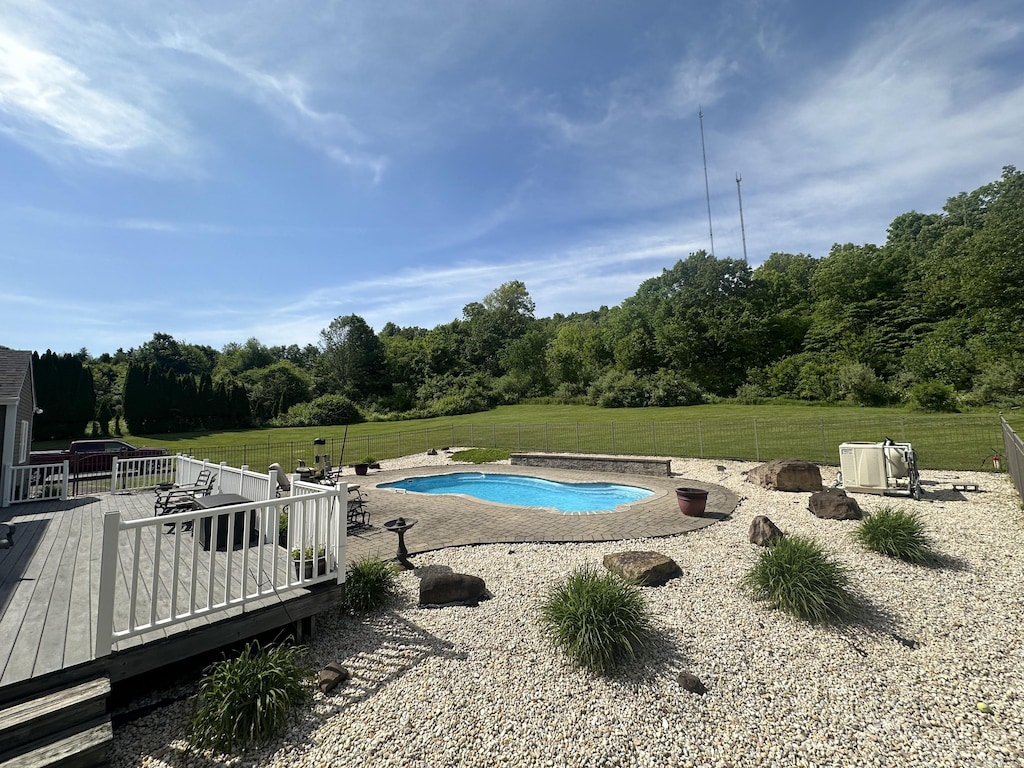7 Trumbull Ln, Farmington, CT 06032 - view of pool featuring a wooden deck, a lawn, and a view of trees