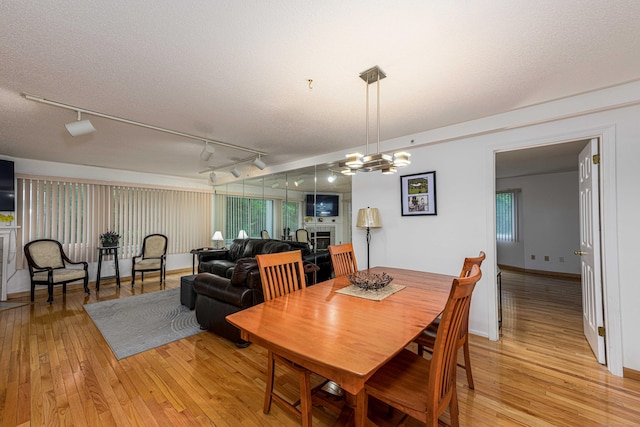 2 Mansfield Grove Rd Apt 160, East Haven, CT 06512 - dining space featuring rail lighting, light wood finished floors, and a textured ceiling