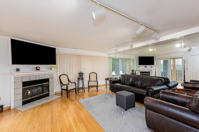 2 Mansfield Grove Rd Apt 160, East Haven, CT 06512 - living room with a fireplace, track lighting, wood-type flooring, and a textured ceiling