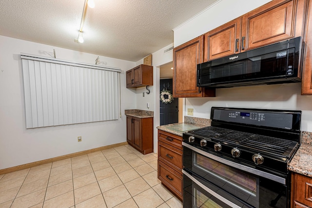 2 Mansfield Grove Rd Apt 160, East Haven, CT 06512 - kitchen featuring black appliances, brown cabinets, a textured ceiling, baseboards, and light tile patterned floors