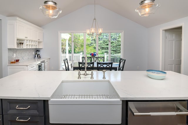 156 Main St, Ridgefield, CT 06877 - kitchen with dishwasher, lofted ceiling, white cabinets, light stone countertops, and hanging light fixtures