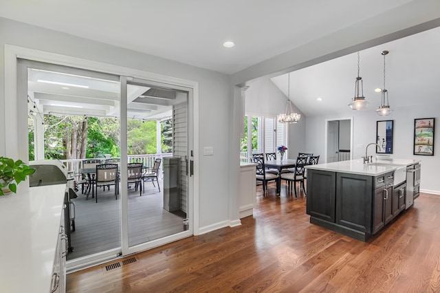 156 Main St, Ridgefield, CT 06877 - kitchen featuring a sink, light countertops, a chandelier, baseboards, and dark wood-type flooring