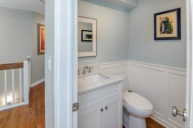 156 Main St, Ridgefield, CT 06877 - bathroom with vanity, toilet, wainscoting, and wood finished floors