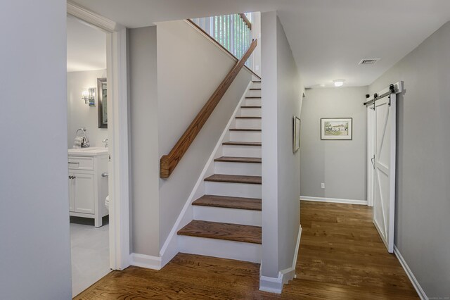 156 Main St, Ridgefield, CT 06877 - staircase featuring wood finished floors, a barn door, and baseboards