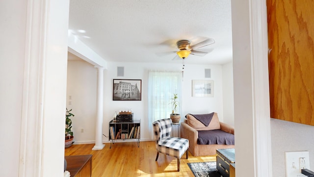 77 Bassett Rd, North Haven, CT 06473 - sitting room with a ceiling fan, ornate columns, and light wood-style floors
