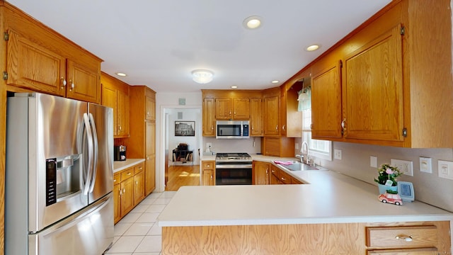 77 Bassett Rd, North Haven, CT 06473 - kitchen with appliances with stainless steel finishes, a sink, light countertops, a peninsula, and recessed lighting