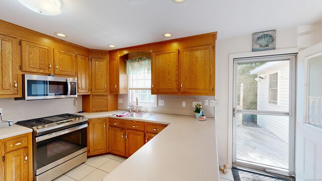 77 Bassett Rd, North Haven, CT 06473 - kitchen with stainless steel appliances, light countertops, healthy amount of natural light, and recessed lighting