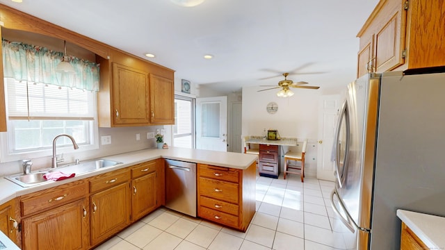 77 Bassett Rd, North Haven, CT 06473 - kitchen with appliances with stainless steel finishes, a sink, a peninsula, light countertops, and healthy amount of natural light