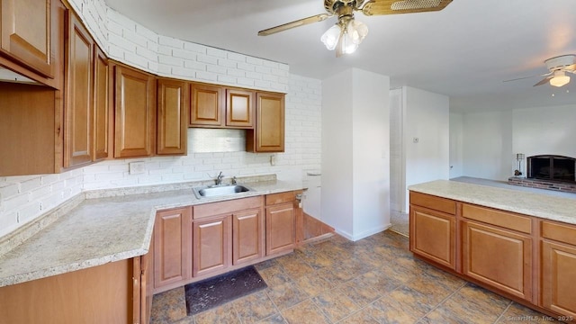 77 Bassett Rd, North Haven, CT 06473 - kitchen with ceiling fan, a sink, backsplash, and light countertops