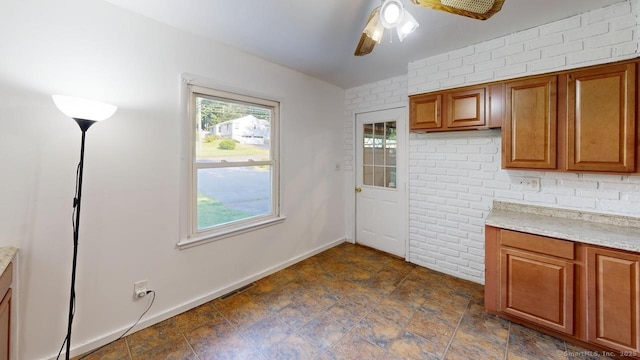 77 Bassett Rd, North Haven, CT 06473 - kitchen featuring a ceiling fan, light countertops, brown cabinets, and baseboards