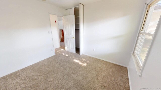 77 Bassett Rd, North Haven, CT 06473 - unfurnished bedroom featuring carpet and baseboards