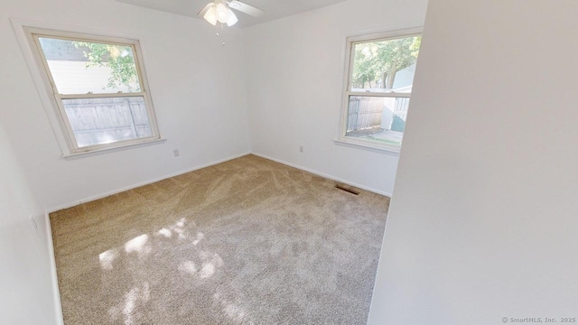 77 Bassett Rd, North Haven, CT 06473 - carpeted spare room with plenty of natural light, a ceiling fan, and baseboards