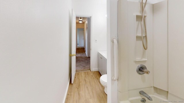 77 Bassett Rd, North Haven, CT 06473 - bathroom featuring wood finished floors, shower / bath combination, toilet, and vanity