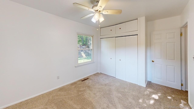 77 Bassett Rd, North Haven, CT 06473 - unfurnished bedroom featuring carpet flooring, a closet, baseboards, and a ceiling fan