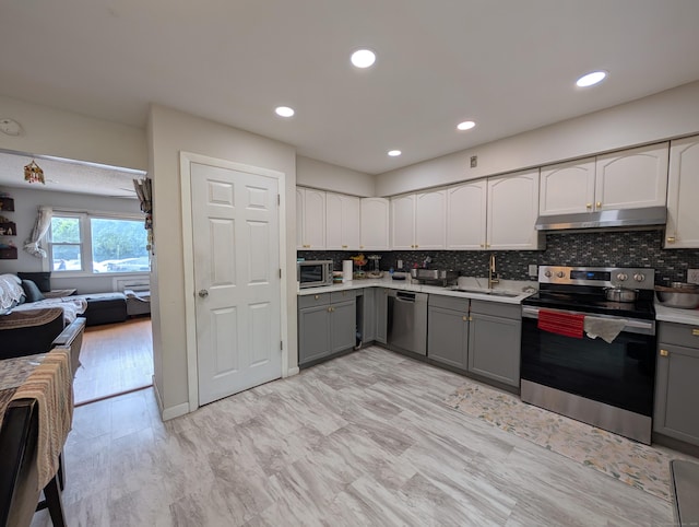 94 Canterbury Rd Unit D, Plainfield, CT 06374 - kitchen featuring stainless steel appliances, gray cabinets, under cabinet range hood, a sink, and recessed lighting