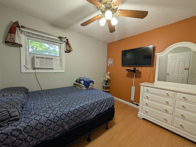 94 Canterbury Rd Unit D, Plainfield, CT 06374 - bedroom featuring light wood-style floors, cooling unit, a ceiling fan, a textured ceiling, and baseboards