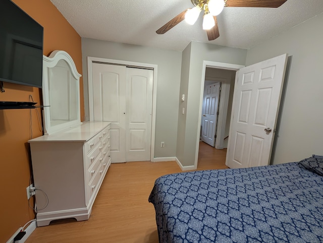 94 Canterbury Rd Unit D, Plainfield, CT 06374 - bedroom with light wood finished floors, a textured ceiling, a closet, ceiling fan, and baseboards