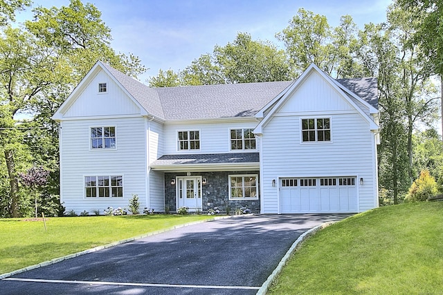 59 Thornhill Rd, Fairfield, CT 06824 - view of front facade featuring driveway, a garage, a front lawn, and roof with shingles