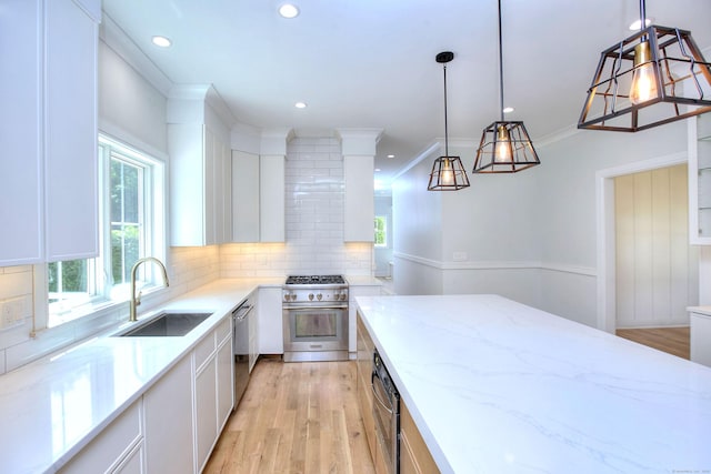 59 Thornhill Rd, Fairfield, CT 06824 - kitchen featuring appliances with stainless steel finishes, a sink, light wood-type flooring, white cabinetry, and recessed lighting