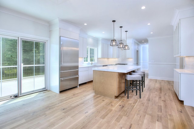59 Thornhill Rd, Fairfield, CT 06824 - kitchen featuring stainless steel built in fridge, a sink, decorative backsplash, a kitchen island, and light countertops
