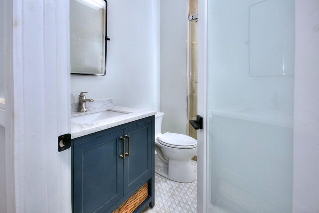 59 Thornhill Rd, Fairfield, CT 06824 - bathroom featuring vanity, toilet, a shower, and tile patterned floors