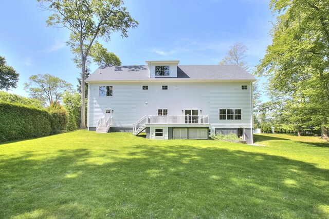 59 Thornhill Rd, Fairfield, CT 06824 - rear view of property with a lawn, a wooden deck, and stairs