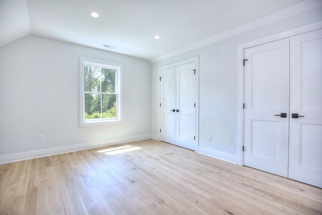 59 Thornhill Rd, Fairfield, CT 06824 - unfurnished bedroom with multiple closets, light wood-style floors, recessed lighting, baseboards, and vaulted ceiling